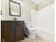 Cozy bathroom featuring tile floors, a granite vanity, a mirror, and tub with shower at 6233 Boulder Dr, Anderson, IN 46013