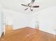 Bright bedroom features hardwood floors, ceiling fan and view of the adjoining bathroom at 6233 Boulder Dr, Anderson, IN 46013