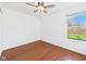 Bedroom features hardwood floors, a ceiling fan and a window with backyard views at 6233 Boulder Dr, Anderson, IN 46013