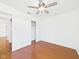 Bright bedroom with hardwood floors and ceiling fan has access to a full hallway at 6233 Boulder Dr, Anderson, IN 46013