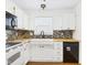 White kitchen featuring a white apron sink, butcher block countertops, and mosaic backsplash at 6233 Boulder Dr, Anderson, IN 46013
