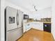 Bright kitchen featuring stainless steel refrigerator, white cabinets, and wood countertops at 6233 Boulder Dr, Anderson, IN 46013