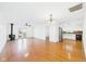 Open-concept living area with hardwood floors, fireplace, and stainless steel appliances in adjacent kitchen at 6233 Boulder Dr, Anderson, IN 46013