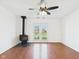 Spacious living area with hardwood floors, wood burning fireplace, and glass doors to backyard at 6233 Boulder Dr, Anderson, IN 46013