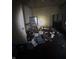 Bedroom with clutter and debris on the floor, cabinets, mirror, and window at 630 Congress Ave, Indianapolis, IN 46208