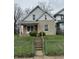 Modest two-story home featuring tan brickwork and a small front porch at 630 Congress Ave, Indianapolis, IN 46208
