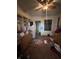 Kitchen with outdated cabinets, appliances, and scattered items on the floor at 630 Congress Ave, Indianapolis, IN 46208