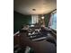 A cluttered living room with green walls and a round patterned rug at 630 Congress Ave, Indianapolis, IN 46208