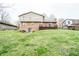 Backyard featuring a spacious lawn, mature trees, and a wood fence at 632 Ridgeview Ln, Columbus, IN 47201