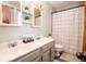 Bright bathroom with a double sink vanity, decorative mirror, and a shower/tub combo at 632 Ridgeview Ln, Columbus, IN 47201