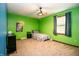 Bright bedroom with green painted walls, a ceiling fan, and ample space for personalization at 632 Ridgeview Ln, Columbus, IN 47201