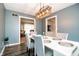 Dining room with views to the kitchen and living room with gray walls and wood floors at 632 Ridgeview Ln, Columbus, IN 47201