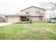 Charming two-story home with a brick facade, inviting front porch, and attached garage at 632 Ridgeview Ln, Columbus, IN 47201