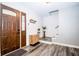 Bright foyer with wood-look floors, a modern wooden cabinet, and staircase at 632 Ridgeview Ln, Columbus, IN 47201