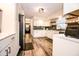 Bright kitchen featuring white cabinets, subway tile backsplash, stainless steel appliances, and updated fixtures at 632 Ridgeview Ln, Columbus, IN 47201