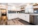 Corner of the kitchen featuring white cabinets, stainless steel appliances, and an eat-in breakfast space at 632 Ridgeview Ln, Columbus, IN 47201