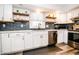 Close up of modern kitchen with updated stainless steel appliances, subway tile, and white cabinets at 632 Ridgeview Ln, Columbus, IN 47201