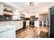 Kitchen with updated appliances, white cabinets, floating shelves and subway tile at 632 Ridgeview Ln, Columbus, IN 47201