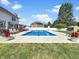 Beautiful backyard with an inground pool, slide, and additional entertainment features at 7034 Endicott Way, Indianapolis, IN 46259