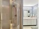 The bathroom features a glass-enclosed shower and a double vanity with modern fixtures and ample lighting at 7034 Endicott Way, Indianapolis, IN 46259