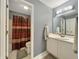 Powder room includes a vanity with storage, mirror and toilet with neutral tones at 7034 Endicott Way, Indianapolis, IN 46259