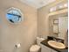 Cozy half bathroom with granite countertops, hexagon window, and modern fixtures at 7034 Endicott Way, Indianapolis, IN 46259