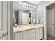 Bright bathroom with double vanity, large mirror, and modern lighting fixtures at 7034 Endicott Way, Indianapolis, IN 46259