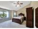 Spacious bedroom featuring a large bed, vaulted ceilings, and natural light from a large window at 7034 Endicott Way, Indianapolis, IN 46259
