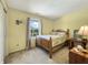 Bedroom features a wood bedframe and natural light through the window at 7034 Endicott Way, Indianapolis, IN 46259