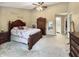 Well-lit bedroom with ceiling fan and warm color tones at 7034 Endicott Way, Indianapolis, IN 46259