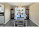 Formal dining room with hardwood floors, elegant chandelier, and backyard view at 7034 Endicott Way, Indianapolis, IN 46259