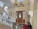 Inviting foyer with high ceilings, decorative door, staircase, and stylish accents at 7034 Endicott Way, Indianapolis, IN 46259