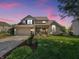 Charming brick home with well manicured lawn, mature trees, and attached two-car garage at 7034 Endicott Way, Indianapolis, IN 46259