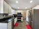 Bright kitchen featuring stainless steel appliances, granite countertops, and modern tile backsplash at 7034 Endicott Way, Indianapolis, IN 46259