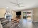 Cozy living room features a fireplace, and access to outdoor pool and patio through sliding glass doors at 7034 Endicott Way, Indianapolis, IN 46259