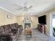 Relaxing living room with fireplace, ceiling fan, and comfortable seating with natural light at 7034 Endicott Way, Indianapolis, IN 46259