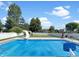 Inviting in-ground pool with slide, basketball hoop, and manicured lawn at 7034 Endicott Way, Indianapolis, IN 46259