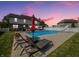 Stunning backyard pool with lounge chairs and slide for summer relaxation and enjoyment at 7034 Endicott Way, Indianapolis, IN 46259