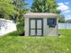 Well maintained backyard shed with double doors, window, and flower box at 7034 Endicott Way, Indianapolis, IN 46259