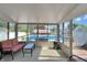 Sunroom features outdoor views of the pool and backyard entertainment area at 7034 Endicott Way, Indianapolis, IN 46259