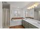 Well-lit bathroom with a double sink vanity and a separate tub at 732 Trillium St, Lebanon, IN 46052