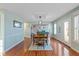 Spacious dining room with hardwood floors, large windows, and modern light fixture at 732 Trillium St, Lebanon, IN 46052