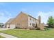 A full view of the property's exterior, showcasing a two-car garage, backyard patio and lush green lawn at 732 Trillium St, Lebanon, IN 46052