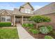 Inviting entryway showcasing a well-maintained lawn, mature landscaping and beautiful brick exterior at 732 Trillium St, Lebanon, IN 46052