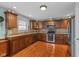 Well-equipped kitchen featuring dark cabinetry, stainless steel appliances, and hardwood floors at 732 Trillium St, Lebanon, IN 46052