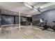 Spacious finished basement featuring a stationary bike and lounge area with durable flooring at 8415 Anchorage Ct, Indianapolis, IN 46236