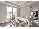 Bright dining area featuring a large window and modern chandelier over a wood table at 8415 Anchorage Ct, Indianapolis, IN 46236