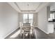 Dining room with a large window and modern chandelier over a light wood table at 8415 Anchorage Ct, Indianapolis, IN 46236