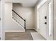 Bright entryway featuring hardwood floors, a staircase with white railings, and a front door with glass panels at 8415 Anchorage Ct, Indianapolis, IN 46236