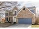 Charming two-story brick home with attached gray garage and well-maintained front yard at 8415 Anchorage Ct, Indianapolis, IN 46236